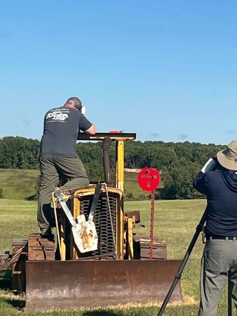 Shooter using a yellow bulldozer as a firing platform on Stage 1 at Recon By Fire range